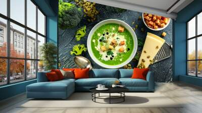 Dietary Broccoli smooth cream soup with sprinkle of sunflower seeds, parsley leaves and croutons on stone table. Wall mural