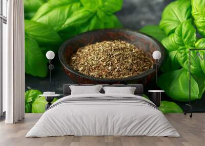 Fresh and dried basil in bowl. on black rustic table Wall mural