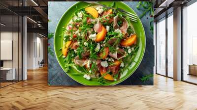 Fresh Peach salad with Parma ham, feta cheese and vegetables in a green plate. healthy food Wall mural