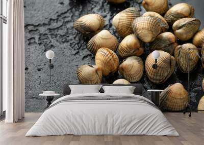 Fresh raw cockle molluscs in heart-shaped shells, sea food shellfish on dark background Wall mural