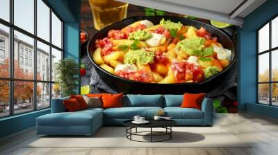 Loaded potato nachos with melted cheddar cheese, sour cream, tomato salsa, chilli, guacamole and beer Wall mural