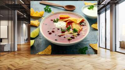 Mexican Chilli bean soup with yogurt, cheese, lime and tortilla chips in white bowl Wall mural