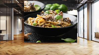 Porcini and woodland mushrooms pasta with pecorino cheese, basil in black bowl Wall mural