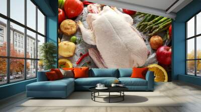 Raw Duck on baking paper with variety of vegetables Wall mural