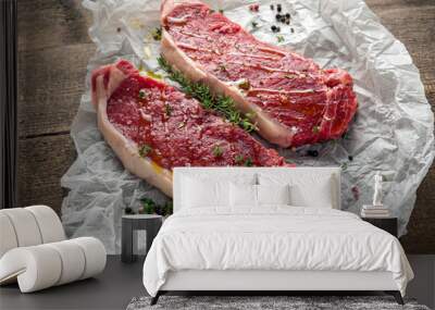 raw premium beef sirloin steak with thyme and papper corn and sea salt seasoning drizzled with olive Wall mural