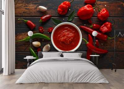 spicy hot sweet chili sauce with mix of chilli pepper, garlic and tomatoes on rustic wooden background Wall mural