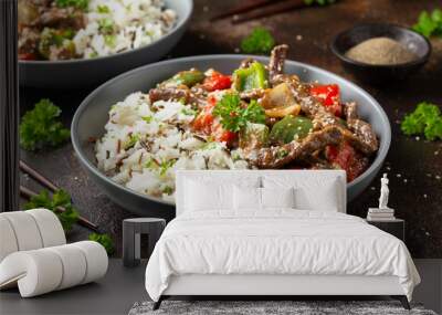 Stir fry Chinese pepper beef steak with onion, red and green bell pepper, rice in bowl Wall mural