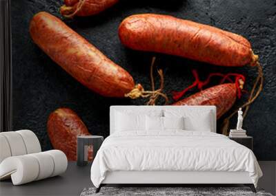 traditional Balearic raw cured meat sobrassada sausage made from ground pork, paprika and spices on rustic black background Wall mural