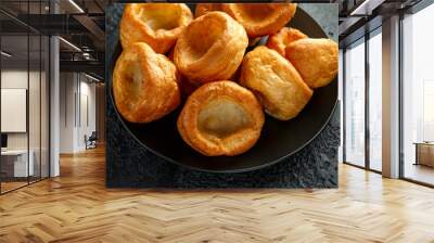 Traditional English Yorkshire pudding side dish on black plate and background Wall mural