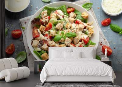 Vegetarian ceasar salad with meat free chicken pieces cherry tomatoes croutons and lettuce in white plate. Wall mural