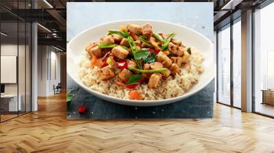 Vegetarian meat free mycoprotein pieces vegetable stir fry, brown rice served in white plate Wall mural