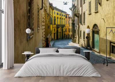 Woman walking down a street in Italy Wall mural