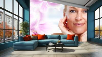 Beautiful woman face over floral background. Wall mural