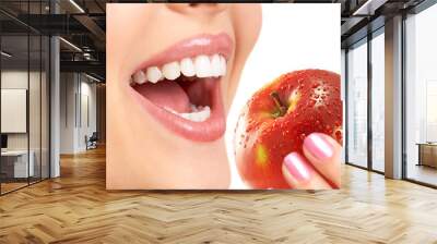 beautiful young woman eating an apple. isolated over white. Wall mural