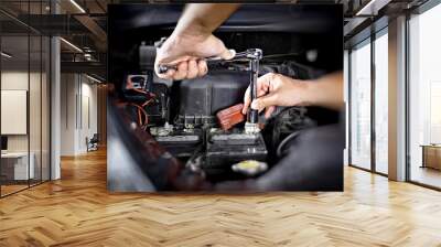 Hands of car mechanic with wrench in garage. Wall mural