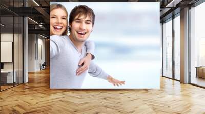 Happy loving couple over blue background. Wall mural