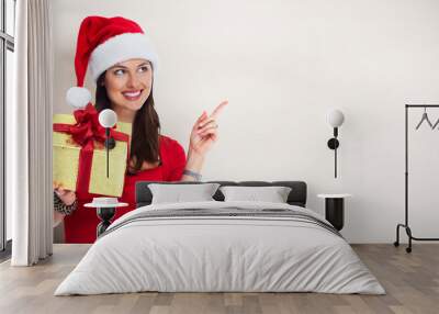 Santa woman with Christmas gift. Wall mural