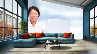 Young business woman with laptop. Wall mural