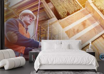 Construction materials for a new house. Engineer with a tablet on a construction site. A man in a construction uniform against the background of the future wooden cottage. Wall mural