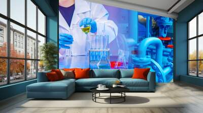 Lab technician pours liquid from a test tube. Research at a chemical plant. Work as a laboratory assistant at a chemical plant. Many pipes a hazardous waste processing plant. Fertilizer development Wall mural