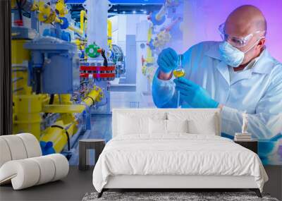 Production for the development of chemical preparations. Concept - chemically dangerous production. A man holds a test tube with liquid in his hands. Chemist-technologist controls the quality Wall mural