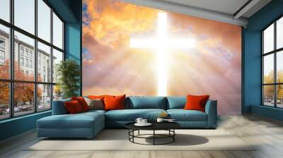 The Christian cross among the clouds. Religion. Support of the faithful. Religious signs and symbols. Light pours from the cross in the sky. Wall mural