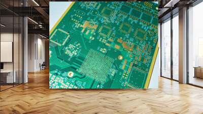 The green printed circuit board is located diagonally. A board for attaching microchips. Production of printed circuit boards. Microboard on a grey background. PCB board without processors and labels. Wall mural