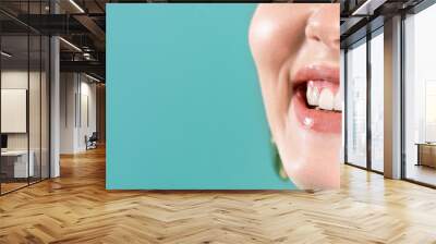 Laughing woman mouth with big teeth on a blue background. Healthy white teeth. Broad smile. Oral care. Wall mural