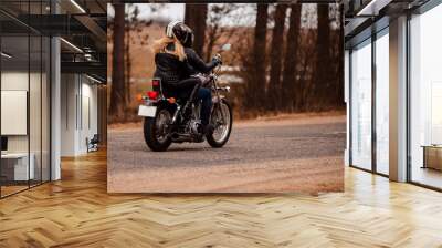 Bikers husband and wife riding a motorcycle on the road Wall mural