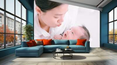 Asian woman holding a newborn baby in her arms at home.Mother day and newborn baby infant health care concept. Wall mural