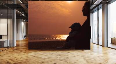 Asian woman with her baby on the beach during sunset, feelings, natural lifestyles. Family background. Wall mural