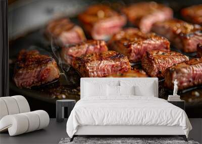 Close-up of Wagyu steak sizzling in a pan on a wood table, searing juices and releasing aromas Wall mural