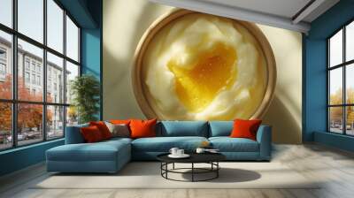 Close-up overhead of yogurt with honey drizzle, studio lighting, beige bowl on a white table, bright color, light shadow, clinical photograph with afternoon light. Wall mural