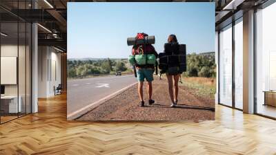 Travel man hitchhiking. Backpacker on road Wall mural