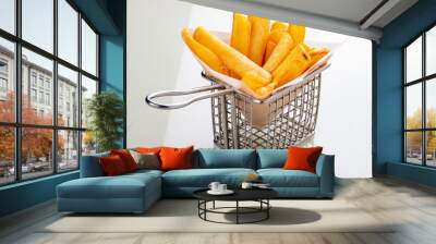 French fries in metal wire basket isolated on a white background Wall mural