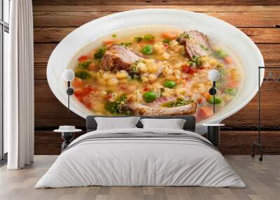 Pea soup with pork ribs. On a wooden background Wall mural