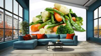 Steamed vegetables on white background. Cauliflower, peas, broccoli, carrots and asparagus beans. Wall mural