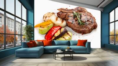 Veal bone steak with grilled vegetables on a white background Wall mural