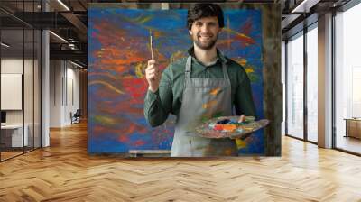 Portrait of an artist male is holding a brush  Wall mural