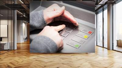 Woman's hand covers his hand when entering your PIN into an ATM Wall mural