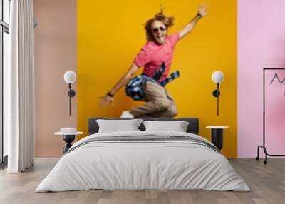 Collage of excited young people jumping against colorful backgrounds Wall mural