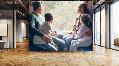 Family with two little kids enjoying train journey together Wall mural