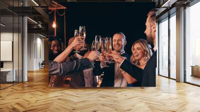 Group of beautiful people in formalwear toasting with champagne and smiling while spending time on luxury party Wall mural