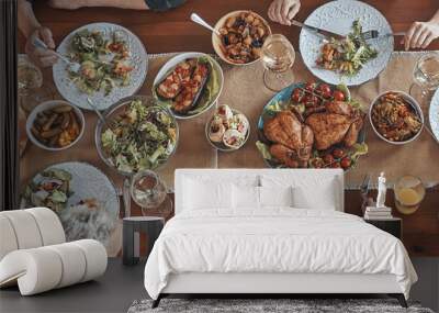 Top view of multi-generation family communicating and smiling while having dinner together Wall mural