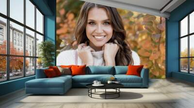 Closeup autumn portrait of a happy young woman outdoor Wall mural