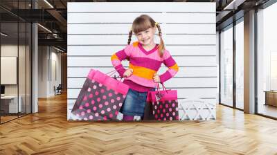 girl in glasses and pink blouse with bags Wall mural