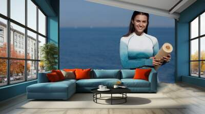 Portrait of a young happy woman with mat Wall mural