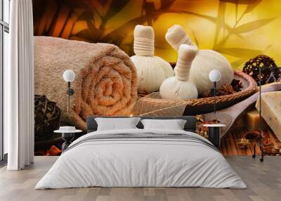 Massage background with rolled towel, spa balls and candlelight Wall mural