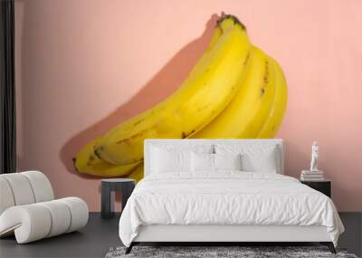 Bunch of bananas on pink background Wall mural