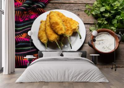 Mexican jalapeno poppers stuffed with cheese and breaded on wooden background Wall mural